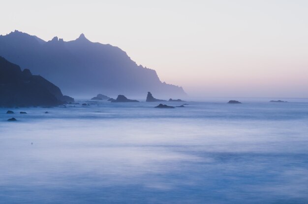 Photo scenic view of sea against sky during sunset