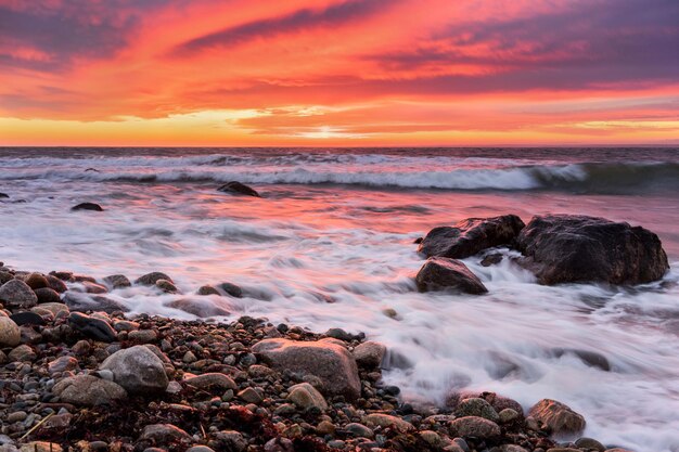 Photo scenic view of sea against sky during sunset