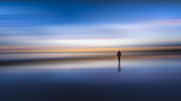 Photo scenic view of sea against sky during sunset