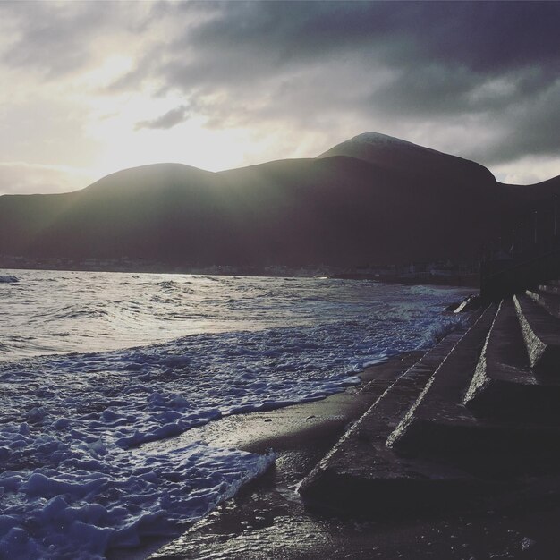 Photo scenic view of sea against sky during sunset