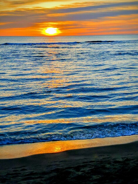 Photo scenic view of sea against sky during sunset