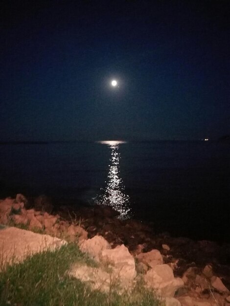 Scenic view of sea against sky at night