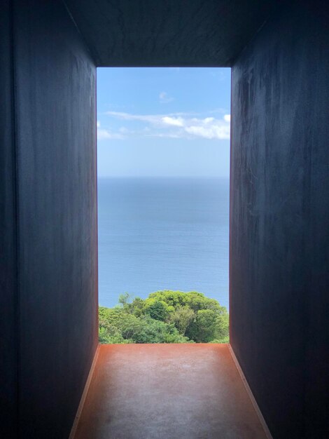 Scenic view of sea against sky seen through window