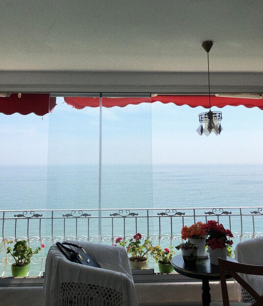 Scenic view of sea against sky seen through window