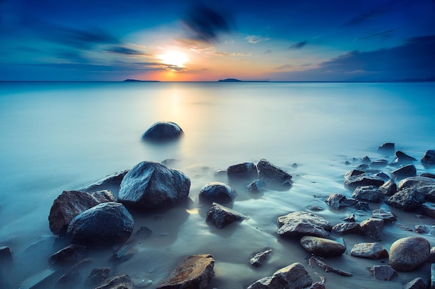 Photo scenic view of sea against sky at sunset