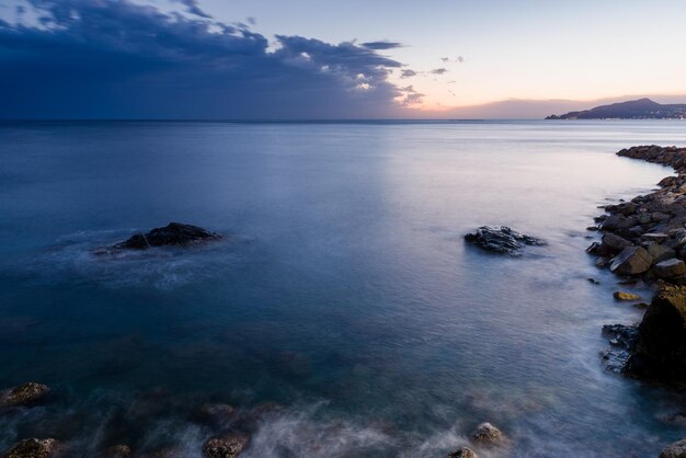 Scenic view of sea against sky at sunset