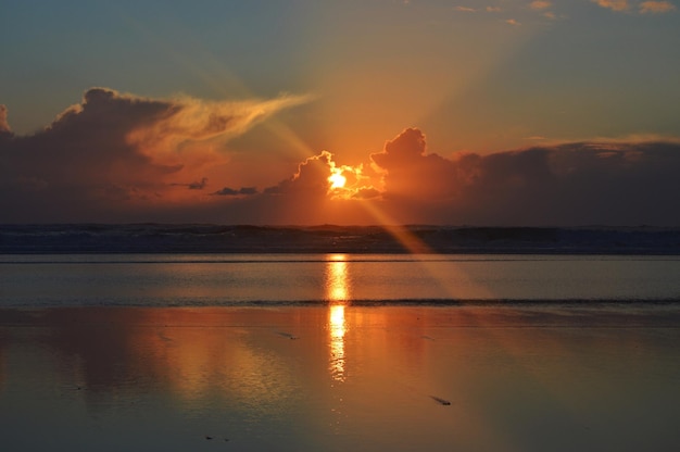 Scenic view of sea against sky at sunset