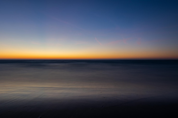 Photo scenic view of sea against sky during sunset