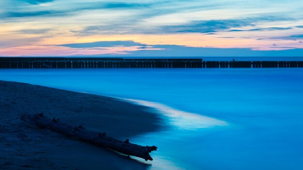 Scenic view of sea against sky at sunset