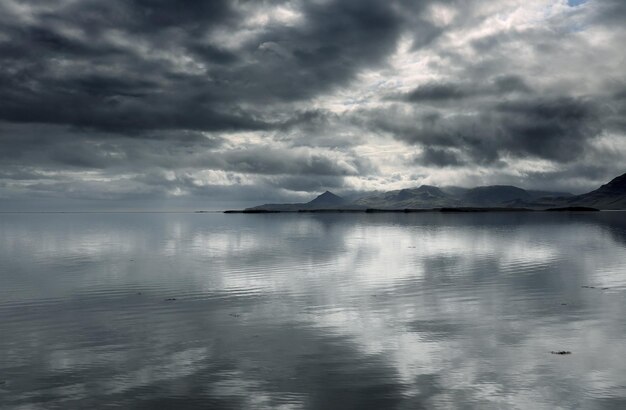 Scenic view of sea against storm clouds