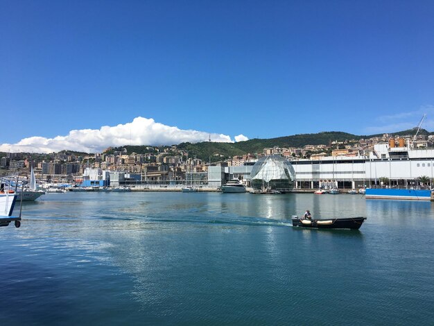 Scenic view of sea and buildings against blue sky