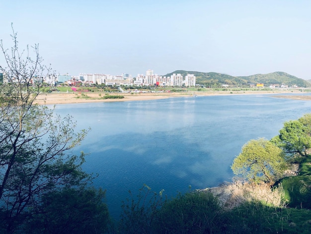 Scenic view of sea and buildings against sky