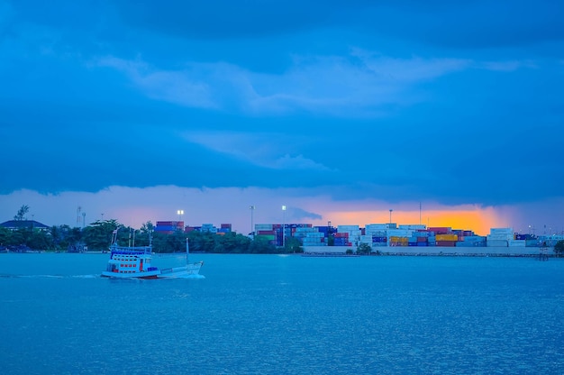 Scenic view of sea by buildings against blue sky