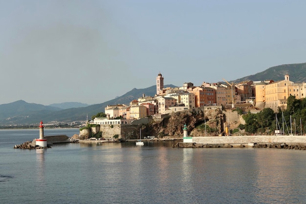 Scenic view of sea by buildings against clear sky