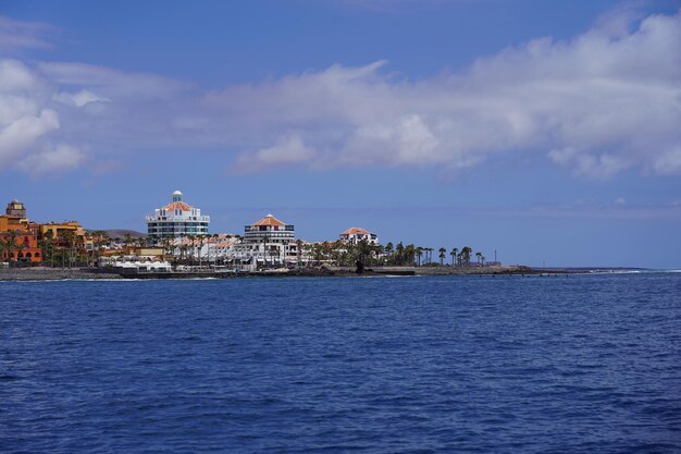 Scenic view of sea by buildings against sky