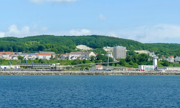 Scenic view of sea by buildings against sky