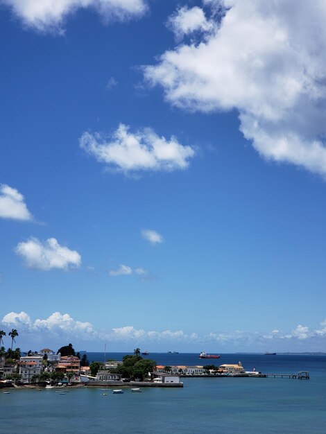 Scenic view of sea by buildings against sky