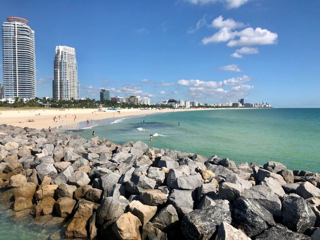 Scenic view of sea by buildings against sky