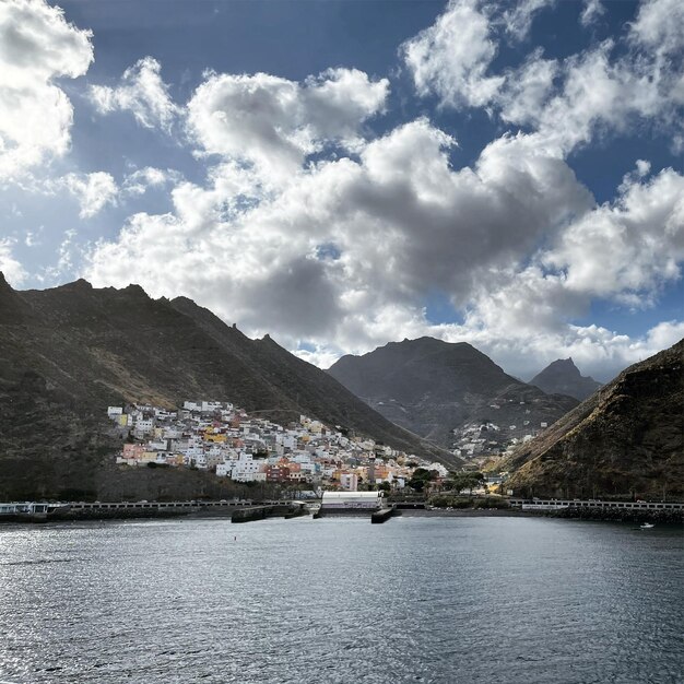 Scenic view of sea by buildings against sky