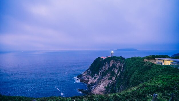 Scenic view of sea by buildings against sky