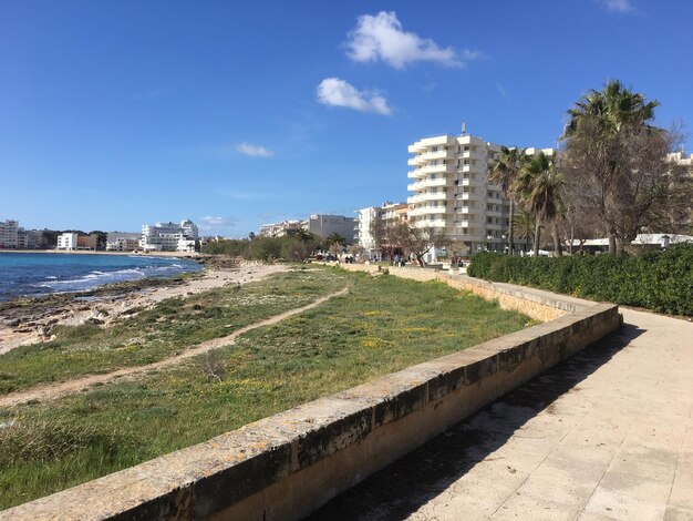 Scenic view of sea by city against sky