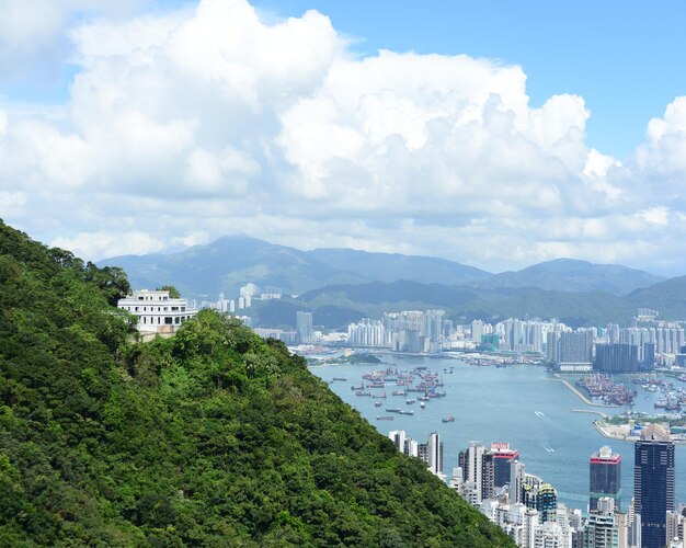 Scenic view of sea by city against sky