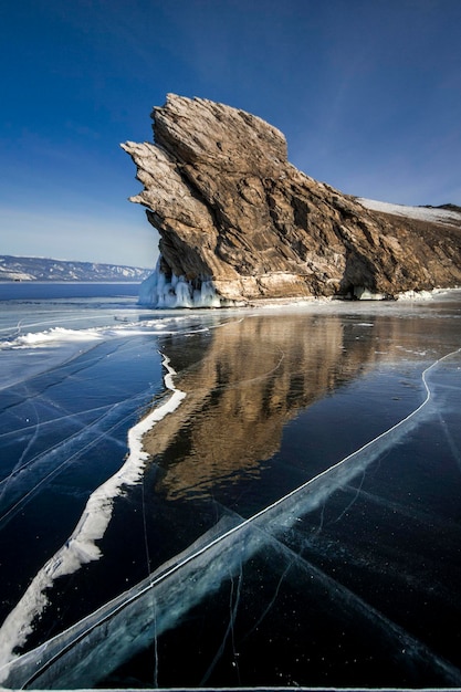 Scenic view of sea by mountain against sky