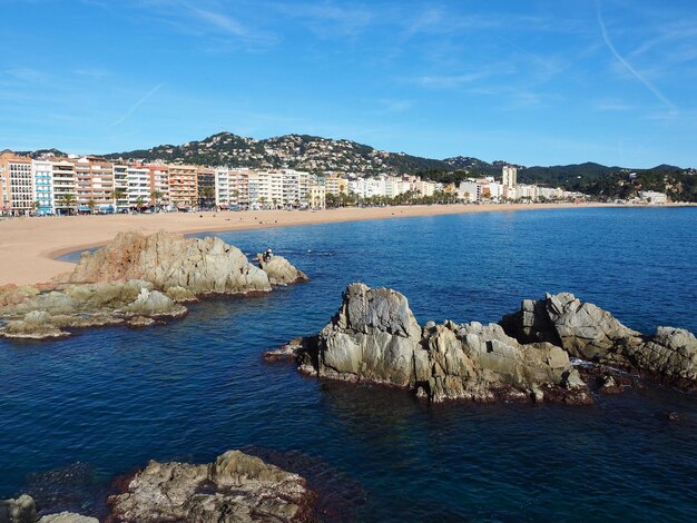 Scenic view of sea by town against sky