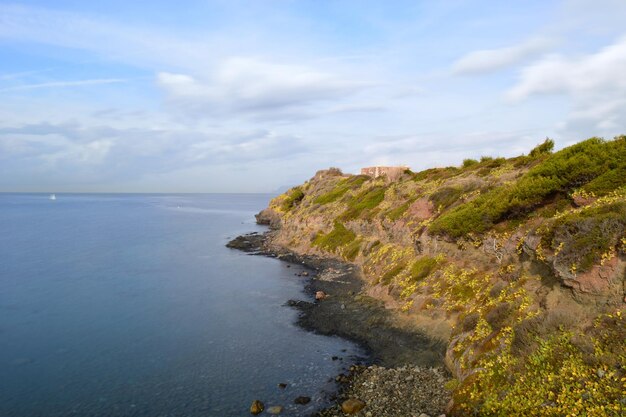 Scenic view of sea and cliff against sky