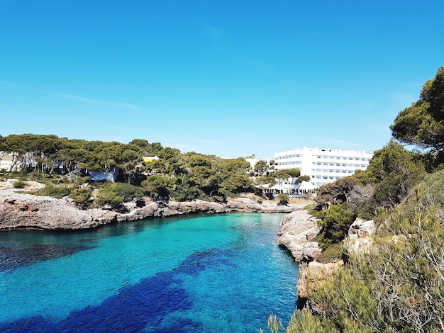 Scenic view of sea and hotel against sky cala dor