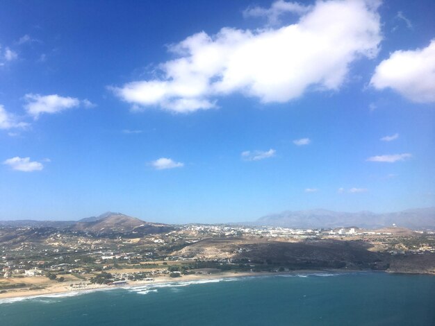 Scenic view of sea and mountains against blue sky