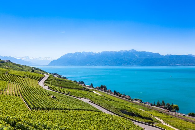 Scenic view of sea and mountains against blue sky