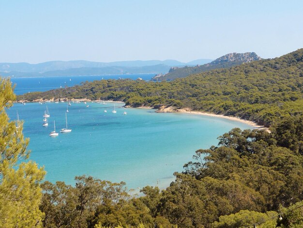 Scenic view of sea and mountains against clear sky