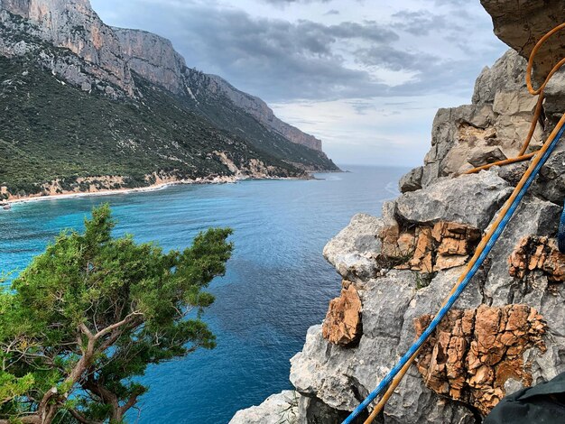 Scenic view of sea and mountains against sky