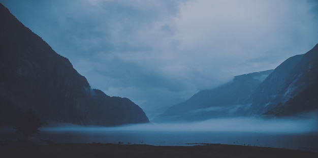 Scenic view of sea and mountains against sky