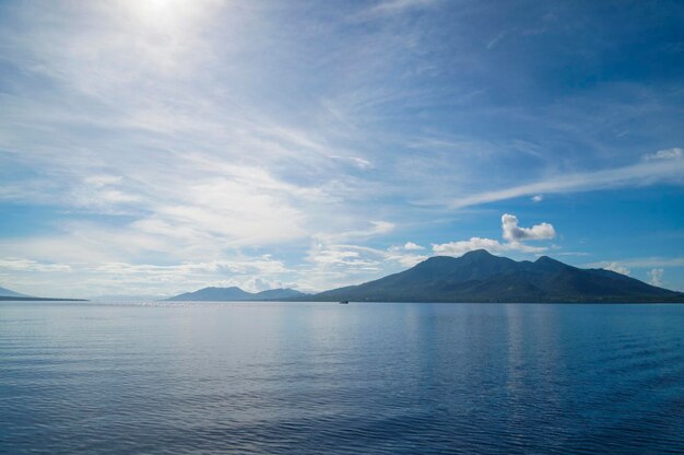 Scenic view of sea and mountains against sky