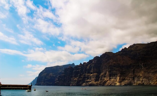 Scenic view of sea and mountains against sky