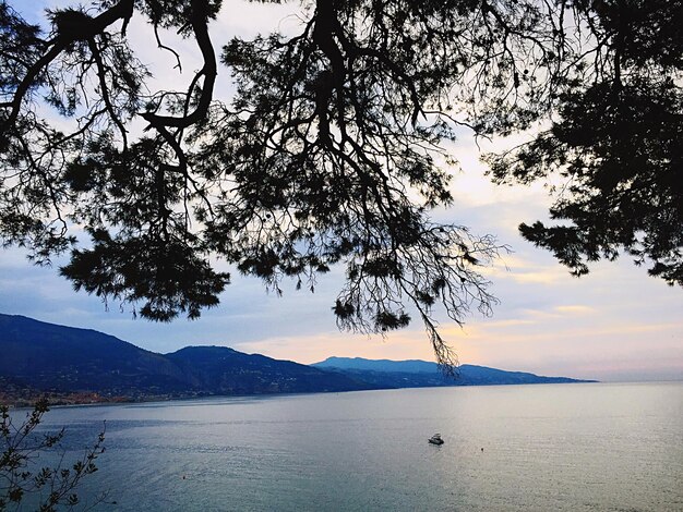 Scenic view of sea and mountains against sky