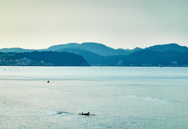 Scenic view of sea and mountains against sky