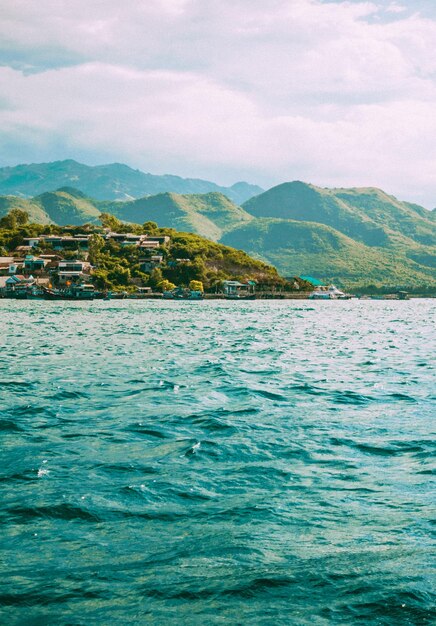 Scenic view of sea and mountains against sky