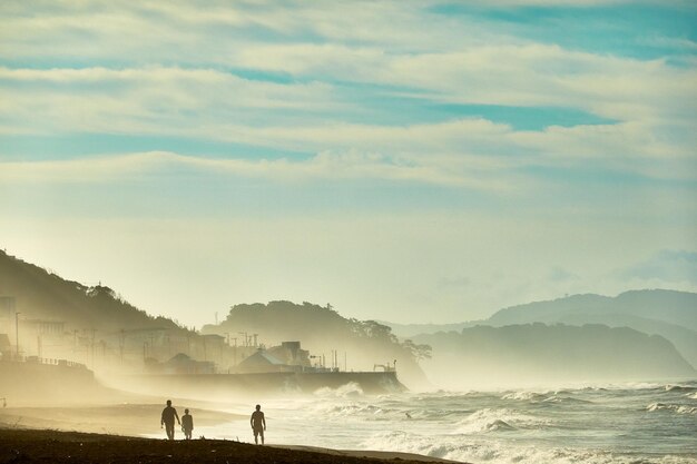 Scenic view of sea and mountains against sky