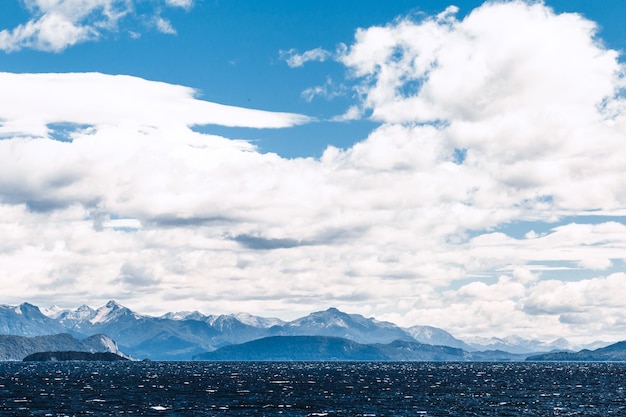 Scenic view of sea and mountains against sky