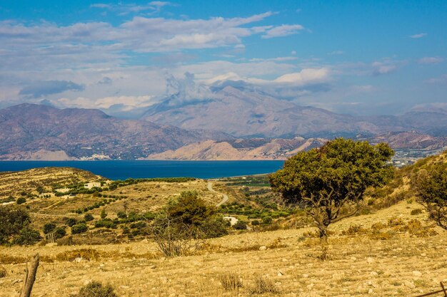 Scenic view of sea and mountains against sky