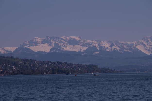 Scenic view of sea and mountains against sky