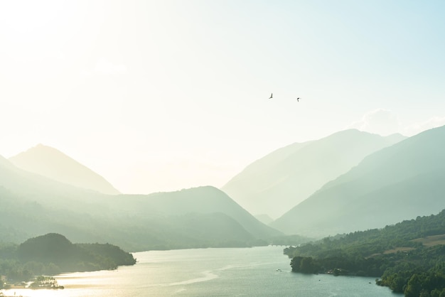 Scenic view of sea and mountains against sky