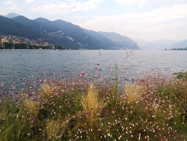 Scenic view of sea and mountains against sky