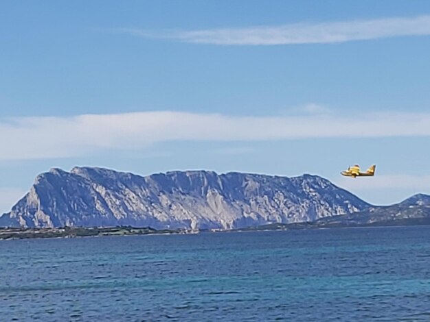 Scenic view of sea and mountains against sky