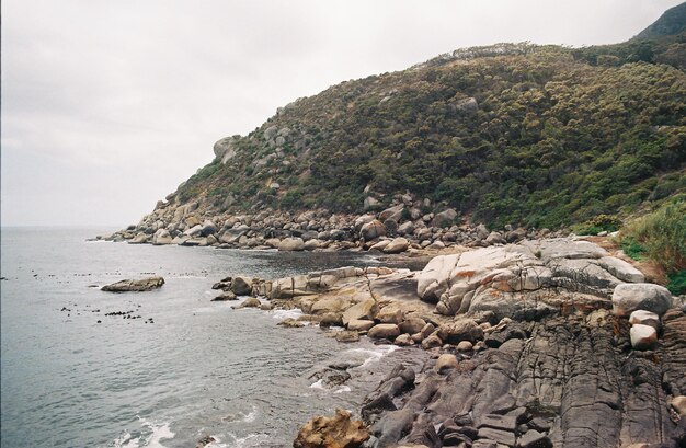 Scenic view of sea and mountains against sky