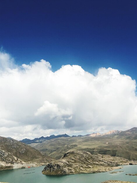 Scenic view of sea and mountains against sky