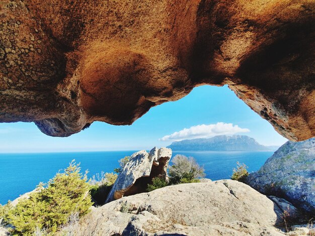 Scenic view of sea and rock formation against sky